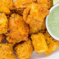 Fish Pakora · Fish dipped in chickpeas batter and fried.