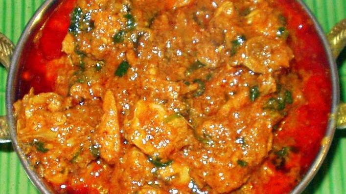 Kodi (Chicken) Pulusu · Chicken with bone cooked in a tangy aromatic sauce.