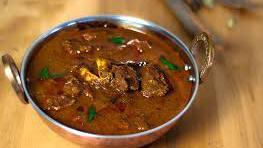 Goat Curry · Goat hunks cooked in onion and tomato sauce.