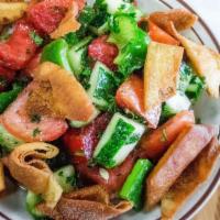 Fetoush Salad · Freshly cut tomatoes, cucumbers, bell peppers, toasted pita chips, and fresh herbs. Prepared...