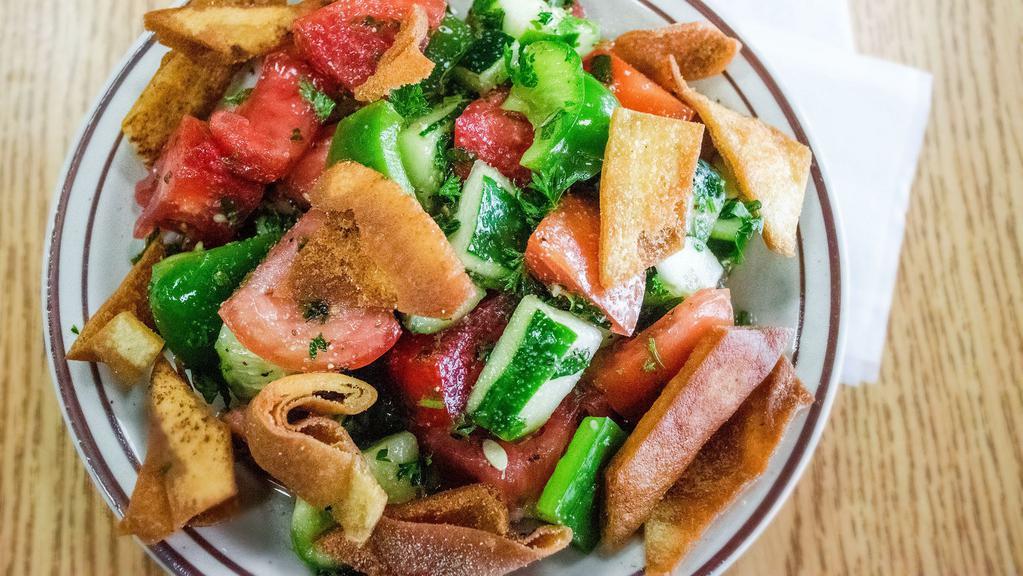 Fetoush Salad · Freshly cut tomatoes, cucumbers, bell peppers, toasted pita chips, and fresh herbs. Prepared with extra virgin olive oil.