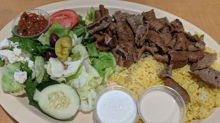 Gyros Plate · Seasoned blend of thinly sliced beef and lamb served with tzatziki sauce, rice, salad, and pita bread.