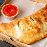 Spinach Calzone (Large) · Shredded mozzarella, ricotta, spinach, served with tomato sauce.