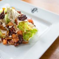 Hyde Park Wedge · Smoked bacon, candied pecans, heirloom tomatoes ,blue cheese dressing, port wine drizzle