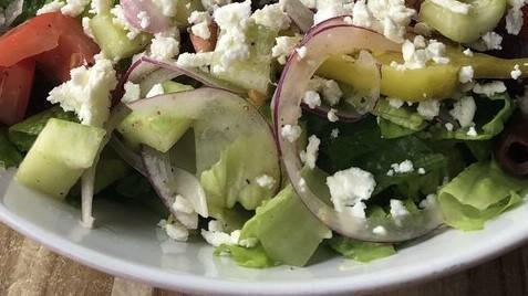 Greek Salad · Gluten-Free. Romaine lettuce, kalamata olives, red onions, cucumbers, Roma tomatoes, feta cheese, pepperoncini, lemon vinaigrette.