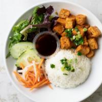 Spicy Lemongrass Tofu Com · Spicy. Spicy sautéed tofu and a side of soy sauce. Steamed rice served with salad with slice...