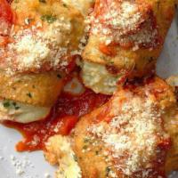 Eggplant Rollatini · Served with garlic rolls. Breaded eggplant stuffed with 3 cheeses, then baked with tomato sa...