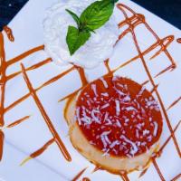 Flan  · Topped with caramel syrup and whipped cream.