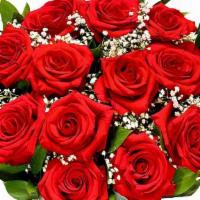 One Dozen Red Roses · One dozen red roses arranged in a glass vase with greenery and filler.