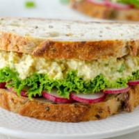 Egg Salad Sandwich · A cold creamy sandwich made with chopped eggs mayo and seasoning.