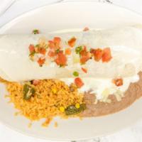 Burrito Texano · Steak, chicken, and shrimp cooked with bell peppers and onions, topped with cheese dip and p...