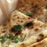Paneer Cheese Naan · Light flat bread stuffed with paneer cheese and fresh green cilantro.