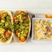 Fish Tacos · Freshly battered white codfish tossed with onions, avocado, tomato, and garnish with coleslaw.