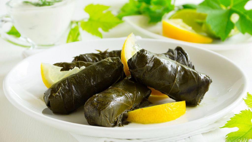 Stuffed Grape Leaves · Fresh grape leaves stuffed with rice, currants, pine nuts and herbs cooked with olive oil.