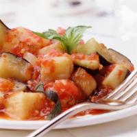 Eggplant With Sauce · Cubes of eggplant baked with olive oil and garnished with tomatoes, green peppers and onions.