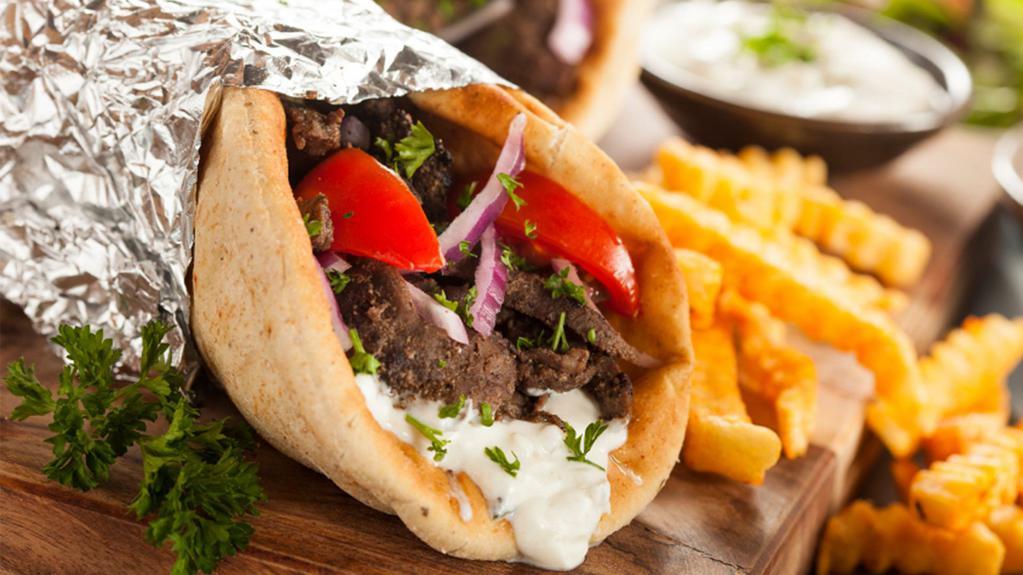 Gyro Wrap · Turkish style gyro meat, lettuce, tomato & onion wrap in pita bread. Side fries and Tzatziki sauce.