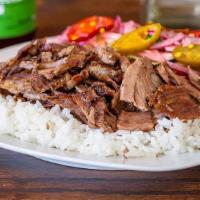 Gyro-Shawarma Plate · Tender lamb and beef , grilled vertically & thinly sliced served over rice and side green sa...