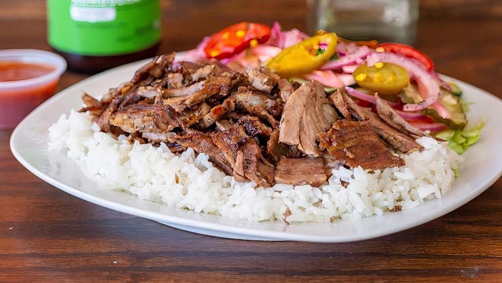 Gyro-Shawarma Plate · Tender lamb and beef , grilled vertically & thinly sliced served over rice and side green salad.