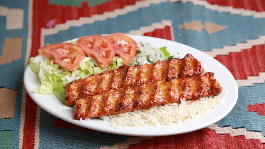 Double Adana Kebab · Freshly ground lamb and beef flavored with red bell peppers & light hot peppers, sprinkled with seasonings and expertly chargrilled on skewers. Served  with rice and salad