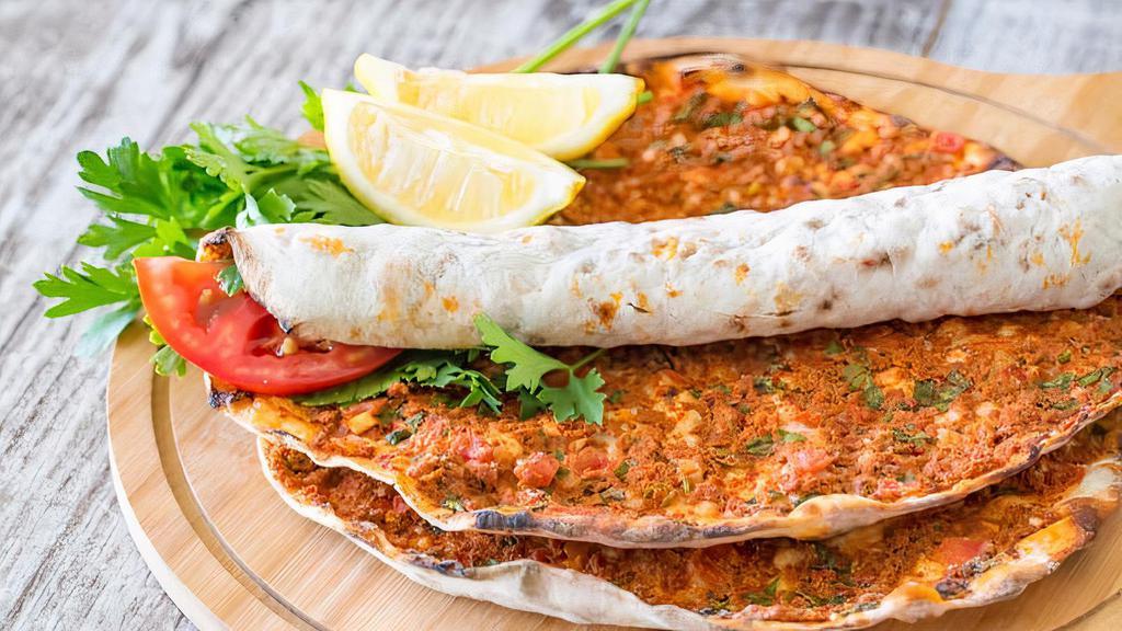 Lahmacun · A Turkish styled pizza. Flat-bread dough topped with fresh ground meat and chopped garden vegetables.