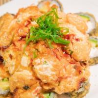 Dynamite Roll · Crab cream cheese in and out with avocado, topped with scallop and masago baked in a special...