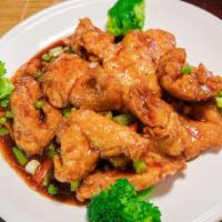 General Tso Chicken · Lightly battered tender chicken breast in a spicy dark brown sauce, served with broccoli. Sp...