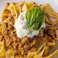 Pappardelle Alla Bolognese · Flat ribbon pasta finished in a veal and beef ragu with a touch of cream.