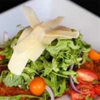 Alla Milanese · Fried topped with tomatoes, arugula, and shaved parmigiano.