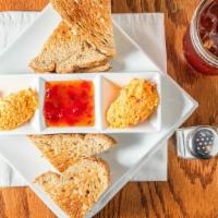 Pimento Cheese · Our homemade pimento cheese served with pepper jelly and toast.