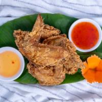 Angel Wings · Chicken wings marinated with special thai spices served with sweet chili sauce.