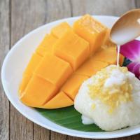 Mango With Sweet Sticky Rice · Fresh mango with sweet sticky rice, coconut milk and yellow seeds.