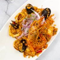 Arroz Con Mariscos · Peruvian style seafood paella, shrimp, mussels, clams and calamari, salsa criolla.