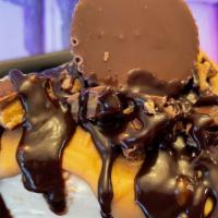 Reese'S Cheesecake Slice · Velvety smooth cheesecake topped with reese's peanut butter cups, peanut butter and chocolat...