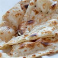Naan · The traditional Pujabi teardrop-shaped white bread is baked in huge flat ovals by slapping i...