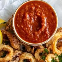 Fried Calamari. · Fried squid (calamari) is quickly deep-fried keeping it crunchy on the outside and simply pe...