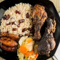 Jerk Chicken Rice Bowl · Grilled jerk chicken over rice and peas, cabbage, and plantains.