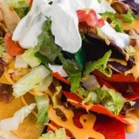 Nachos Supreme · Chili, melted cheddar cheese, sour cream, chopped lettuce, and tomatoes.