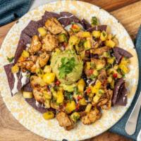 Calypso Nachos · Melting Mexican cheeses, black beans, roasted corn, pineapple salsa, & guacamole.  Top it of...