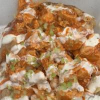Migo · Baked potato stuffed with chicken tossed in a spicy garlic sauce, lightly topped with ranch ...