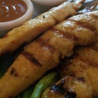 Chicken Satay (4) · Grilled marinated chicken on skewer served with peanut sauce & cucumber vinaigrette.