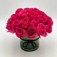 True Hot Pink · This is a perfect round bouquet with 25 hot pink roses, arranged in a cylinder vase with a b...