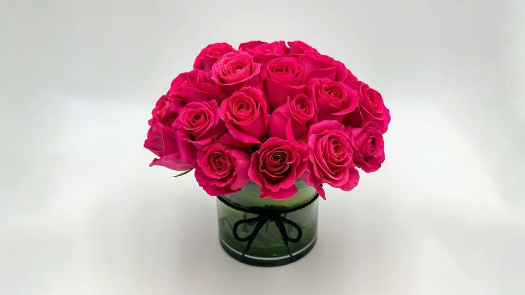 True Hot Pink · This is a perfect round bouquet with 25 hot pink roses, arranged in a cylinder vase with a black tied cord. It is elegant and perfect for any occasion.