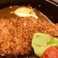 Baked Katsu Curry · Spicy curry, and pork tonkatsu on bed of rice. Side of fukujin zuke ( red pickle) .