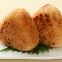 Yaki Onigiri · Two pieces. Grilled salmon rice ball with tamari soy sauce.