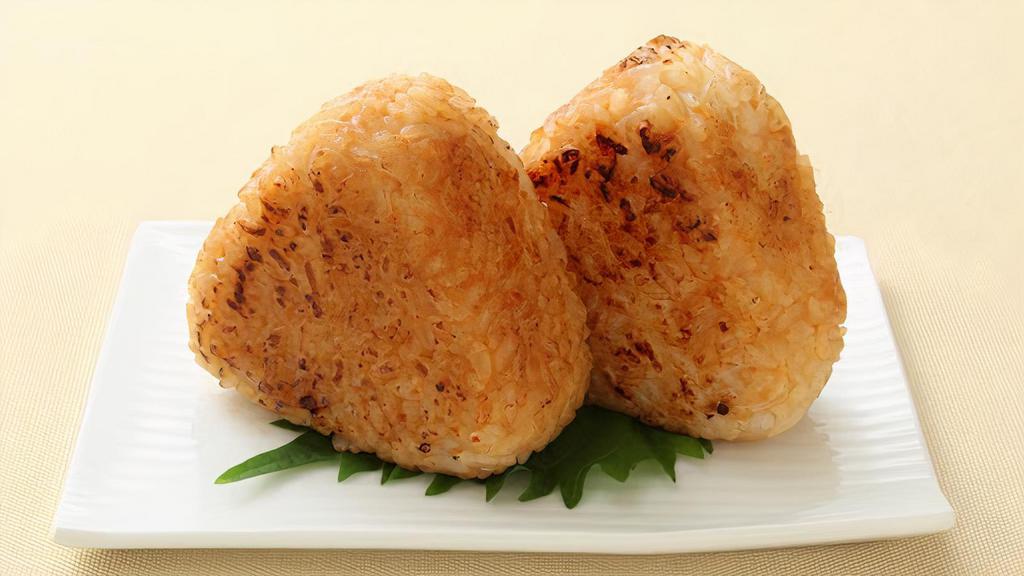 Yaki Onigiri · Two pieces. Grilled salmon rice ball with tamari soy sauce.
