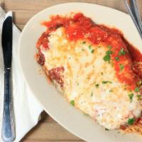Chicken Parmesan · Breaded chicken sautéed in olive oil then baked with marinara and mozzarella cheese. Spaghet...