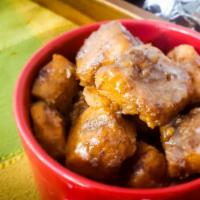 Candied Yams · Slow stewed cinnamon and nutmeg spiced yams topped with butter