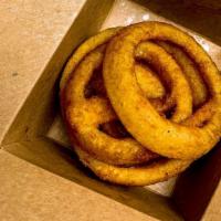 Onion Rings (8 Oz) · Serving of batter-fried onion rings.