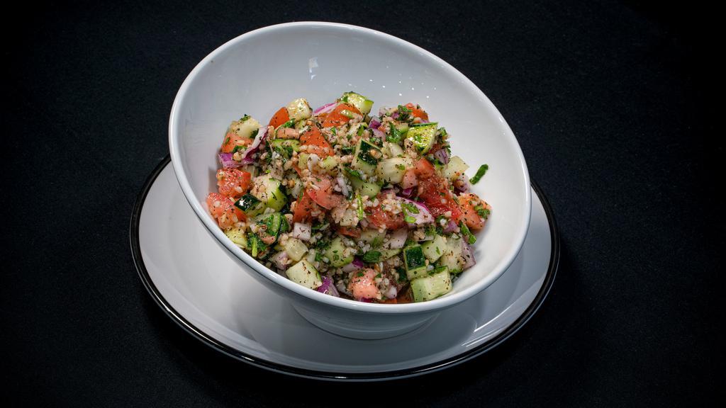 Tabbouleh Salad · Fresh diced tomatoes, cucumbers, Italian parsley, mint, cracked wheat, red onions, fresh lemon juice and extra virgin olive oil.
