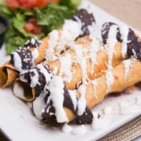 Taquitos · Four crispy corn tortillas rolled with “tinga” braised chicken and smoked Gouda cheese. Driz...